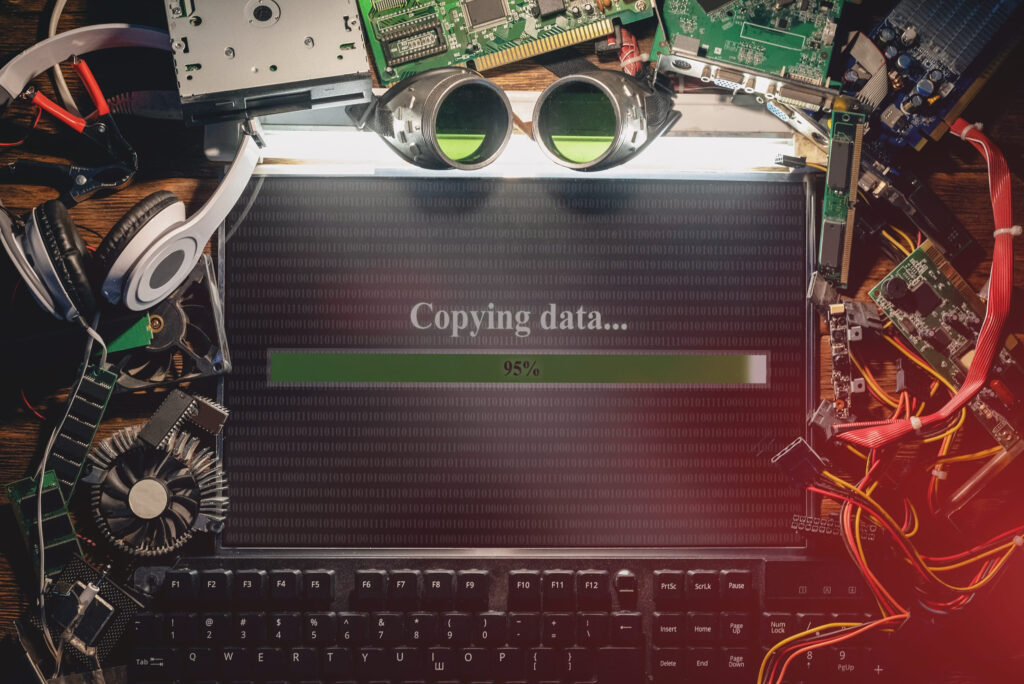 Illegal data copying concept. Flat lay computer and computer parts on the table signifying danger of non POPIA complient E Waste